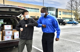 Calvin Ball elbow bumping with resident