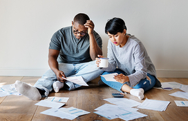 stressed man and woman sitting on the floor