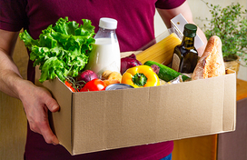 man holding a box of food