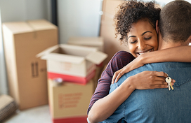 woman holding keys hugging man