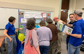 People gather around an informational booth at GreenFest.
