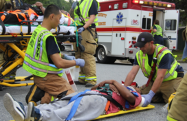 EMS crew provide patient care to patient on stretcher