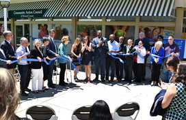 Image of local leaders cutting a blue ribbon on the head start center in long reach village center