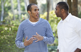 Two men speaking outside