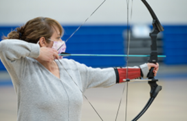 Girl aiming a bow and arrow.