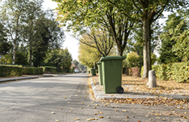 A few trash bins sat out on the curb awaiting pickup