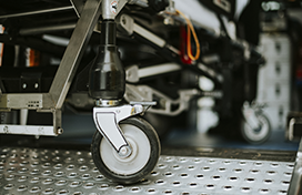 A photo of the wheels of a medical stretcher in an ambulance
