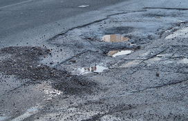 A road with multiple potholes
