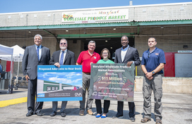 Group of officials standing in front of the Wholesale Produce Market in Jessup