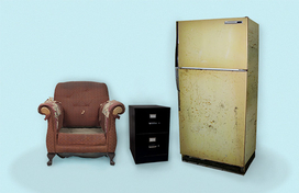 An old chair, a filing cabinet, and an old refrigerator.