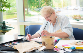 woman smiling while painting