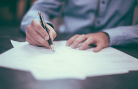 A person writing on some paper