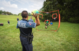 Officer playing sports with neighborhood children