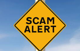 Scam alert sign on post