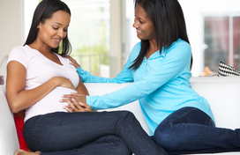 pregnant woman receiving support from another woman
