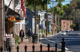 An older couple walking down Ellicott City's Main Street.