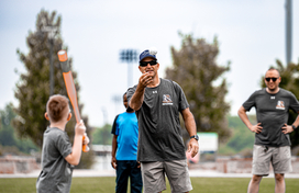 Officer throws ball at batter