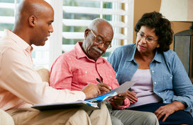 Older adult couple with community service worker