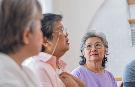 Asian older adults sitting and talking
