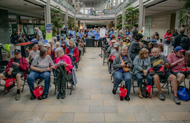 Full view of the audience at the showcase with mall in the background