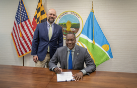 A photo of County Executive Calvin Ball getting ready to sign legislation establishing the county's new flag.