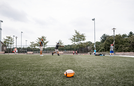 Officers throw ball for young child