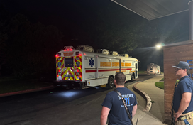 Two firefighters stand by HCDFRS Mobile Ambulance Bus
