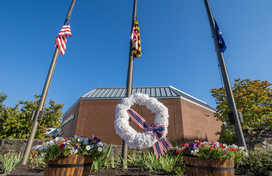 A photo of the County's September 11th Remembrance wreath set up in front of the flag poles out front of the County's George Howard Building in Ellicott City.