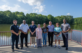 A photo of County Executive Calvin Ball and others with the three heroes that rescue a woman from drowning at Centennial Lake.