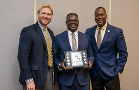 A photo of County Executive Calvin Ball, Department of Finance Director Rafiu Ighile, and three+one CEO Garrett Macdonald with the County's cashVest 90+ Award.