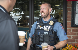 Officer talks to citizen at Coffee with a Cop