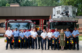 A photo of County Executive Calvin Ball with firefighters out front of Station 10.