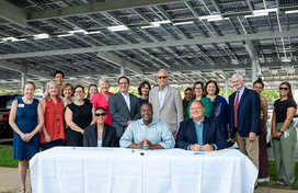 A photo of County Executive Calvin Ball seated at a table with Howard County Public School System Superintendent Bill Barnes and Howard Community College President Dr. Daria J. Willis getting ready to sign a memorandum of understanding to enhance collaboration between the County, HCPSS, and HCC and strengthen local action on climate and sustainability.