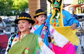 Three dancers in colorful dresses at the 2024 Hispanic Heritage Festival 