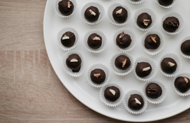 Tray filled with chocolate truffles in paper baking cups.