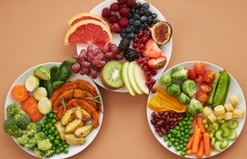 Three plates willed with a colorful mix of fruit and vegetables.