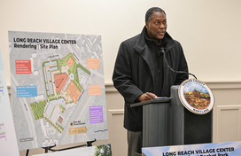 A photo of County Executive Calvin Ball speaking to attendees at this press conference to provide a comprehensive update on the County's Long Reach Village Center Revitalization Project.