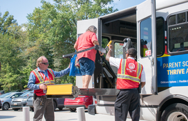 Female older adult testing out public transit lift