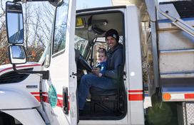 adult with child on lap in highways truck