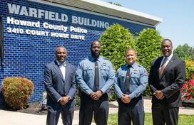 County Executive Calvin Ball (far right) posed out front of the Howard County Police Department's Northern District Warfield Building in Ellicott City with (from left to right) Howard County Council Chairperson Opel Jones, Acting Chief Terrence Benn, and Acting Colonel Antonio Thomas.