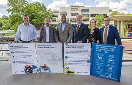 Officials pose with key messages to announce expansion of WiFi access at Columbia Lakefront