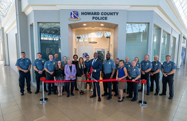 Officials and attendees cut ribbon at new satellite police office at The Mall in Columbia