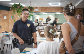 Officer talks to young girl and mom