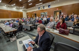 A public Land Development Regulation Assessment being conducted by Clarion Associates. The photo focuses on a male taking notes on a tablet.
