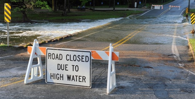 Sign on a road that says road closed due to high water