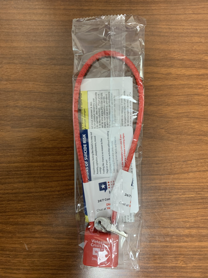 packaged gun lock sitting on a brown table