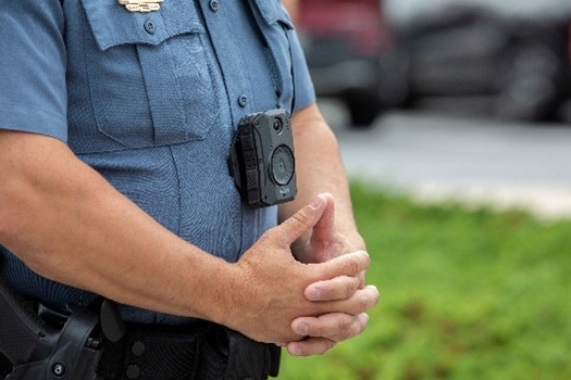Officer with hands folded and thumbs steepled