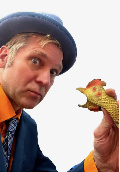 Comedy Juggler Rich Potter holds a rubber chicken