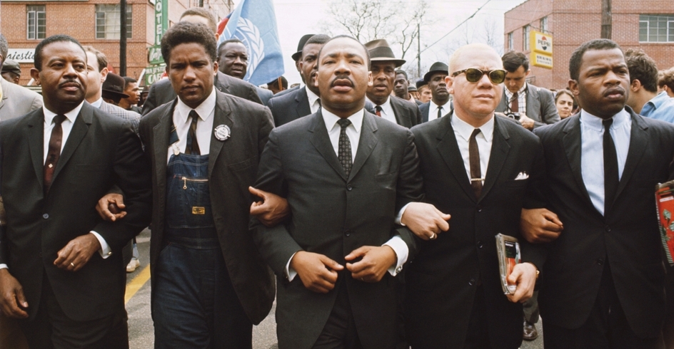 Photo depicting Dr. King's march in Selma, arms interlocked with other men in his group