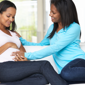 pregnant woman receiving support from another woman